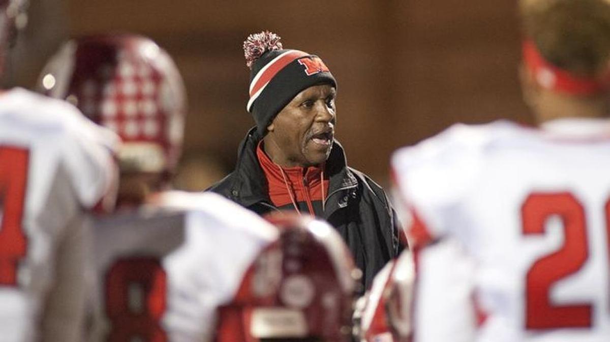 Oliver Lucas (center) has been named the new football coach at Clark County. Lucas previously was at Manual follwing a stint at Bryan Station.
