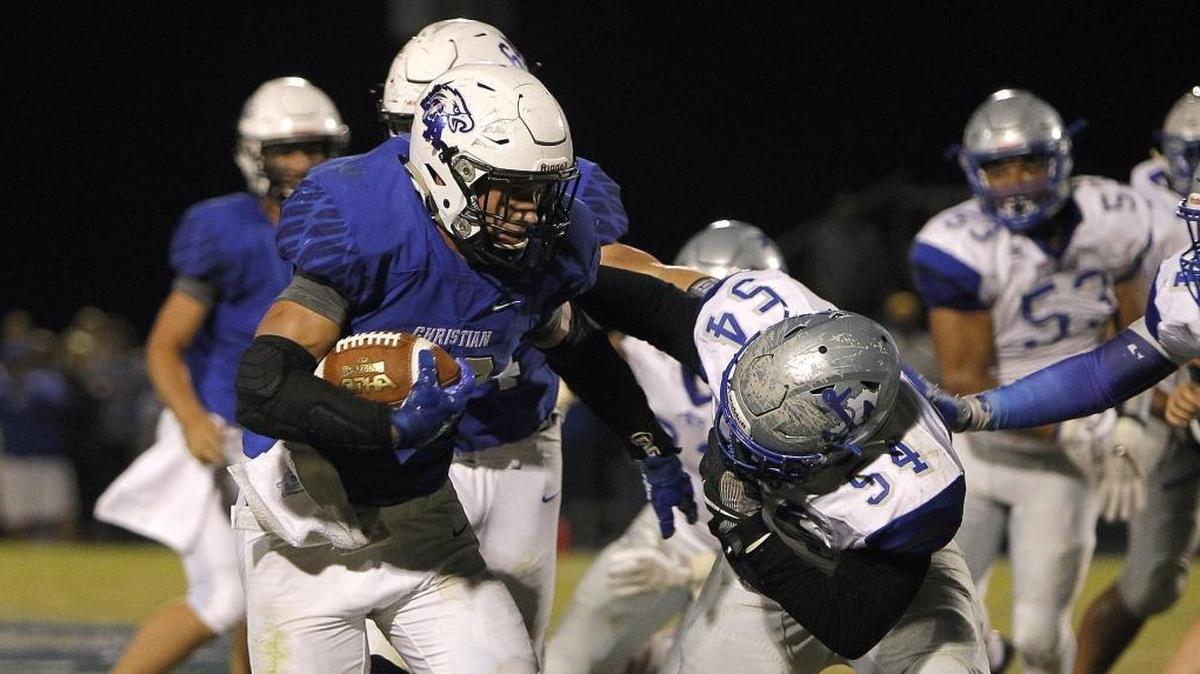 LCA's Dillon Wheatley breaks the tackle against Danville's James Patton at Lexington Christian Academy football stadium in Lexington, Ky., Friday, October 20, 2017.