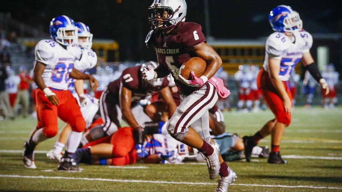 Tates Creek's Laron Warner (6) scores a touchdown past Madison Central defenders in the second quarter of their game at Tates Creek High School in Lexington, Ky., Thursday, Oct. 5, 2017.