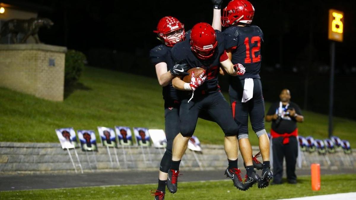 Scott County’s Austin Barnett (20) celebrated a touchdown with teammates Cameron Carpenter (54) and Payton Brown (12) in a victory earlier this season. The Cardinals enter the playoffs with an 8-2 record.