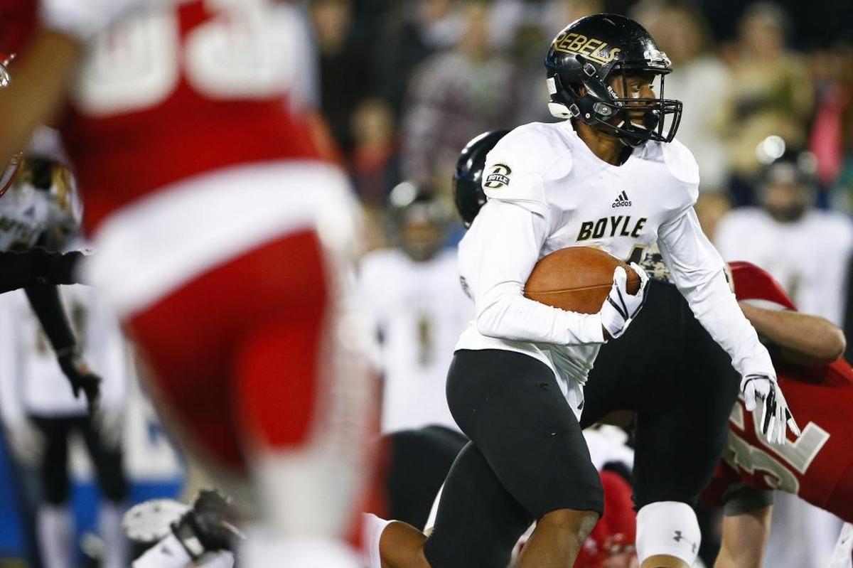 Boyle County’s Landen Bartleson (24) carried the ball between Corbin defenders during last year’s Class 3A state championship game at Kroger Field. Boyle County beat Corbin 40-21.