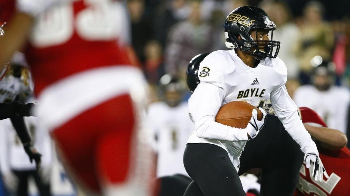 Boyle County’s Landen Bartleson (24) carried the ball between Corbin defenders during last year’s Class 3A state championship game at Kroger Field. Boyle County beat Corbin 40-21.