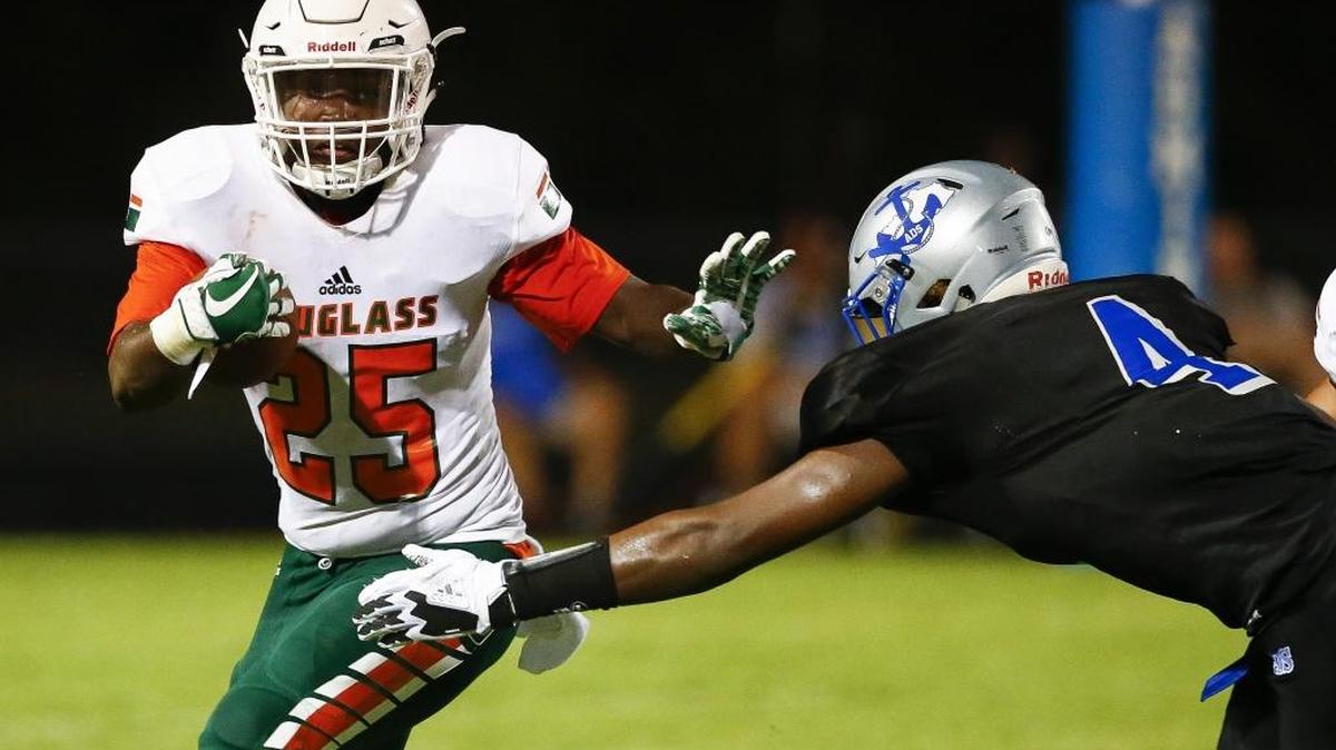 Frederick Douglass' Jefferson Harkless (25) carries the ball past Danville's Jaleel Warren (4) in the first quarter of their their game at Danville High School in Danville, Ky., Saturday, Aug 19, 2017.