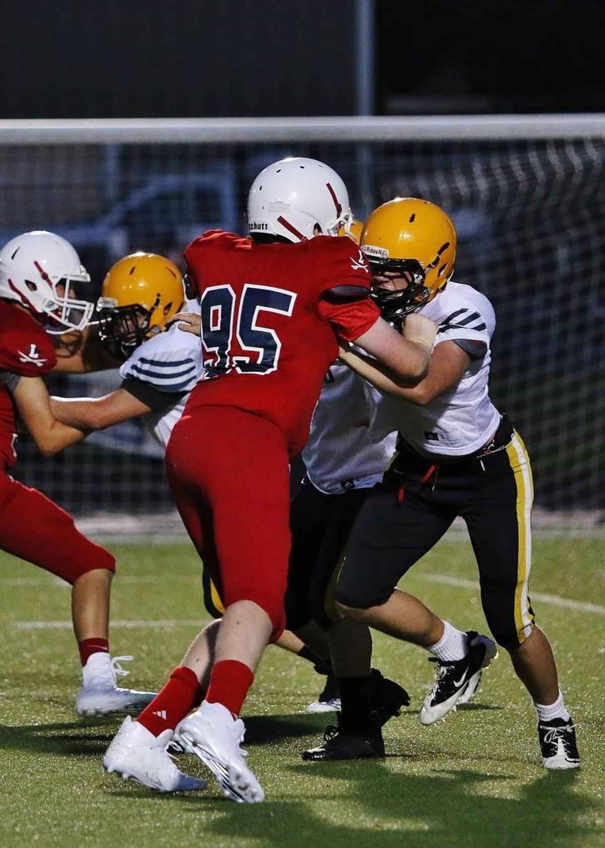 Lafayette High School defensive lineman Will Watkins, left, battled Woodford County High School on Thursday, Aug. 10, 2017.