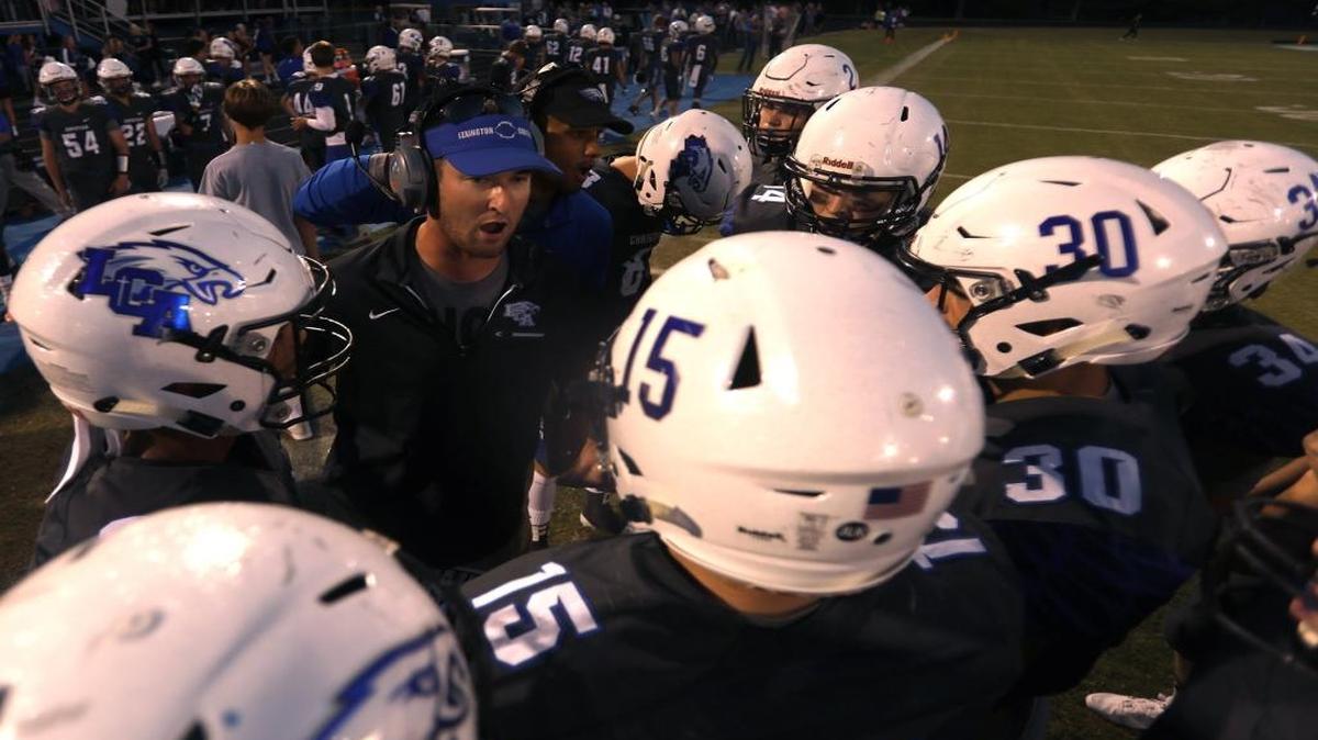 Lexington Christian head coach Ethan Atchley talked to his team during its game against Lexington Catholic on Sept. 8. The Eagles won 56-36.
