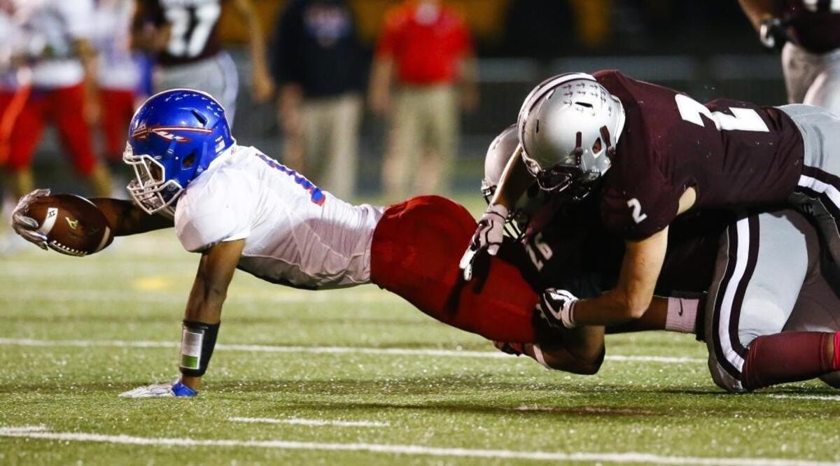 Madison Central's Antwaun Warford (11) dives for a extra yardage while being tackled by Tates Creek's Cameron Stewart (2) and Tates Creek's Teonte White (26) during their game at Tates Creek High School in Lexington, Ky., Thursday, Oct. 5, 2017. Tates Creek beat Madison Central 17-10.
