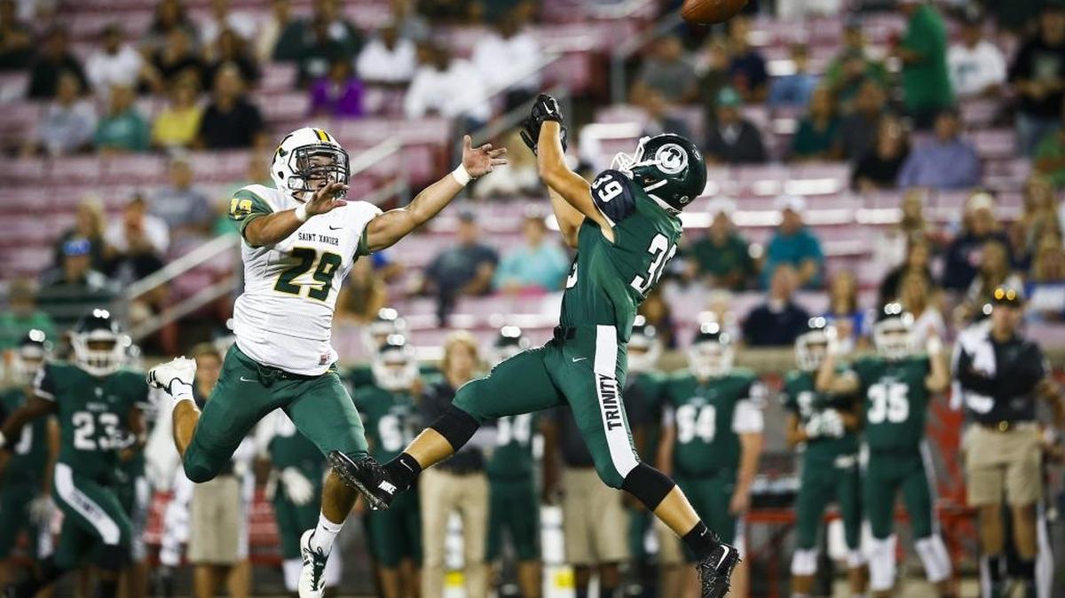 St. Xavier's Harrison Pate (29) breaks up a pass intended for Trinity's Ryan Miller (39) during their game at Papa John's Cardinal Stadium in Louisville, Ky., Friday, Sept. 29, 2017. Trinity beat St. Xavier 28-0.
