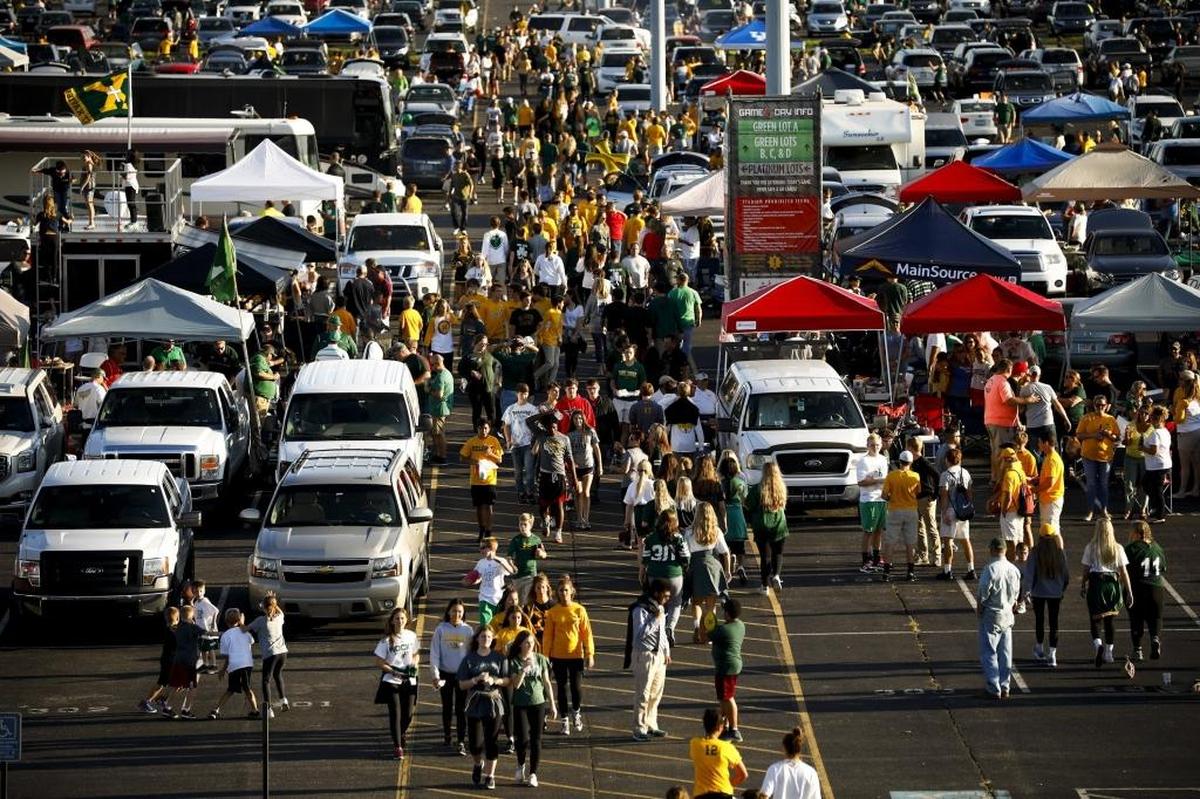 Thousands of fans fill the parking lot before a game between Trinity and St. Xavier at Papa John's Cardinal Stadium in Louisville, Ky., Friday, Sept. 29, 2017. Trinity beat St. Xavier 28-0.