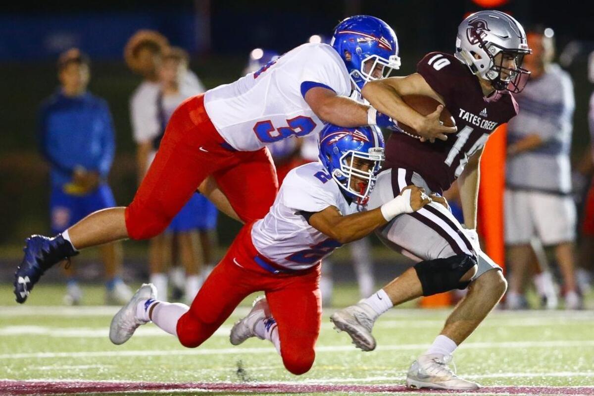 Tates Creek's Cameron Workman (10) runs the ball before being stopped by Madison Central's Levi Gaskins (2) and and Madison Central's Jesse Cox (34) during their game at Tates Creek High School in Lexington, Ky., Thursday, Oct. 5, 2017.