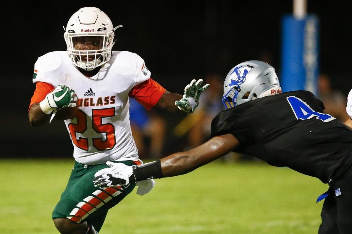 Frederick Douglass' Jefferson Harkless (25) carries the ball past Danville's Jaleel Warren (4) in the first quarter of their their game at Danville High School in Danville, Ky., Saturday, Aug 19, 2017.