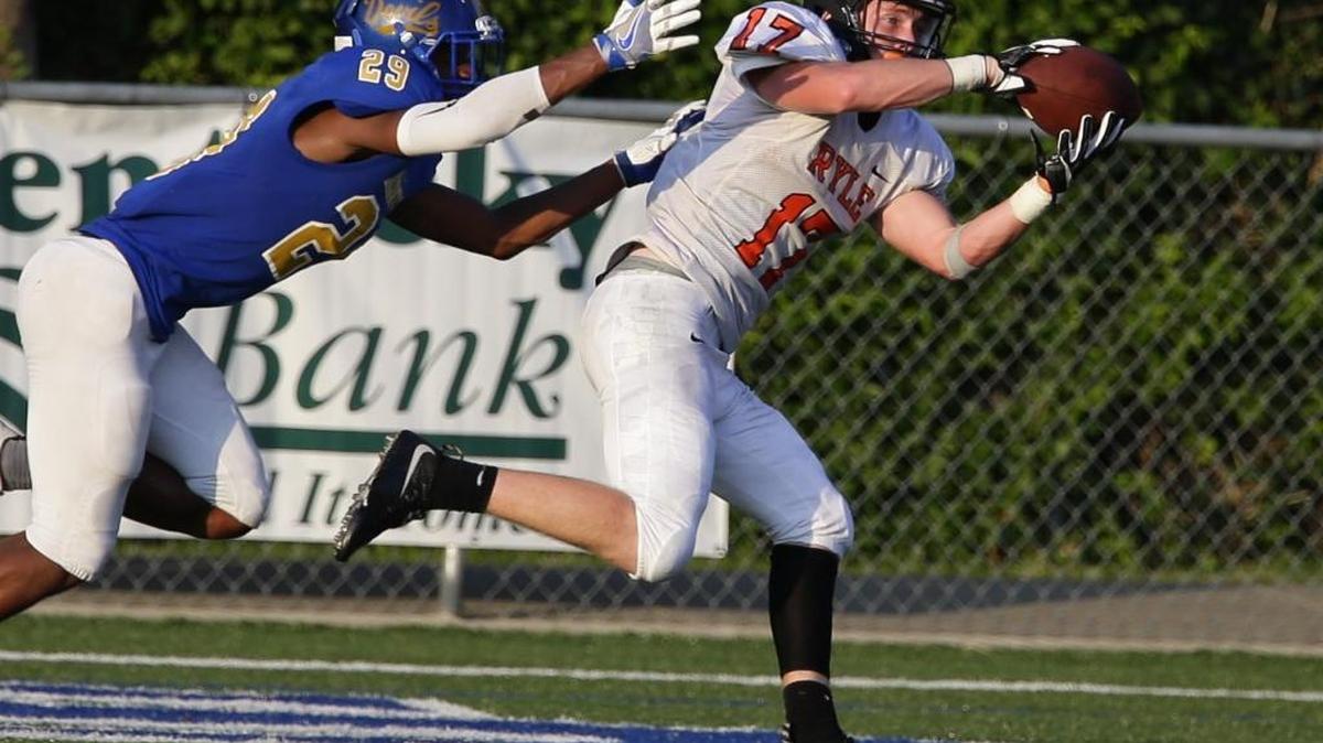 Ryle's Bryce Ashley, 17, pulled in a touchdown pass in front of Tyree Clark, 29, as Ryle defeated Henry Clay 34-28 in the Bluegrass bowl on Friday August 26, 2016 in Lexington, Ky.