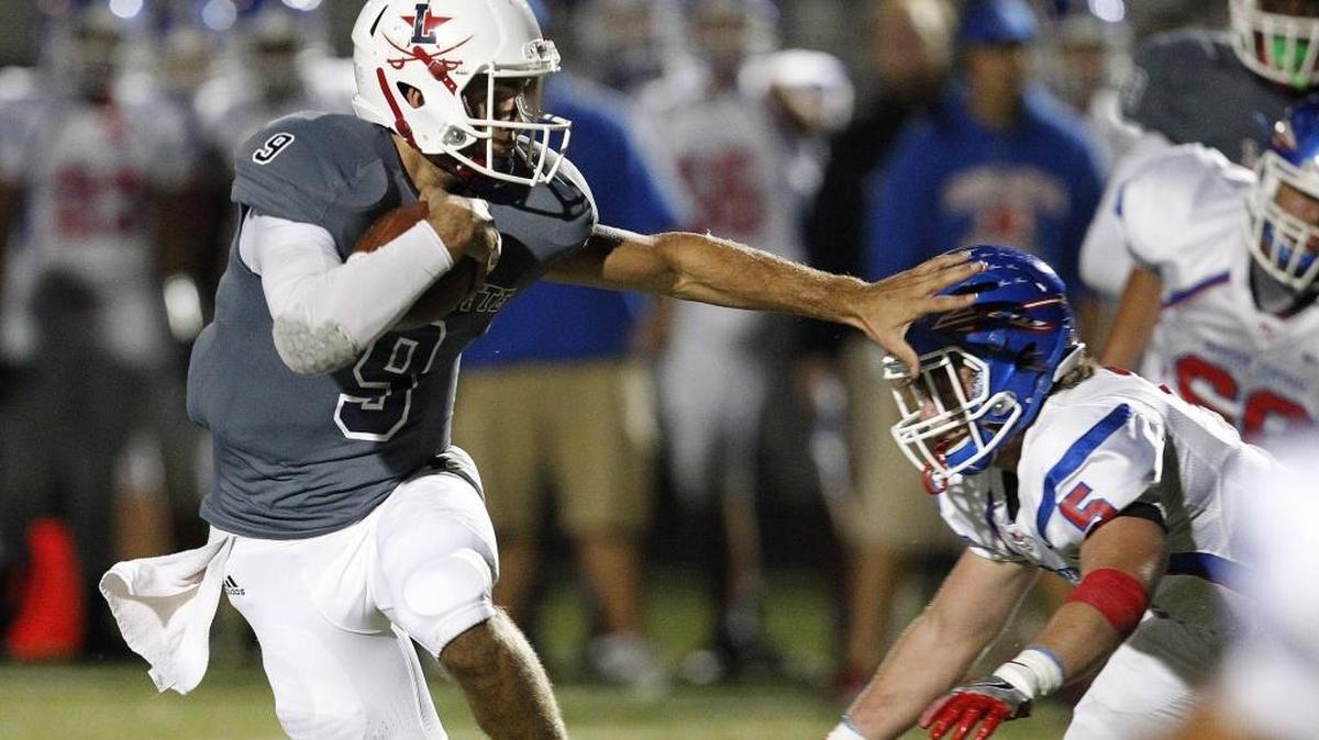 Lafayette QB Walker Wood breaks a tackle while running against Madison Central at Ishmael Stadium in Lexington, Ky., Friday evening, October 14, 2016.