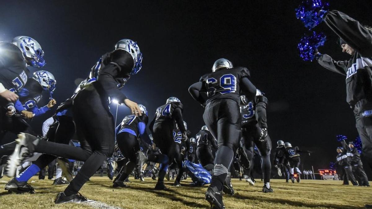 Danville High School players ran onto the field before their game against Covington Holy Cross at Danville High School during the Class 2A football playoffs last fall