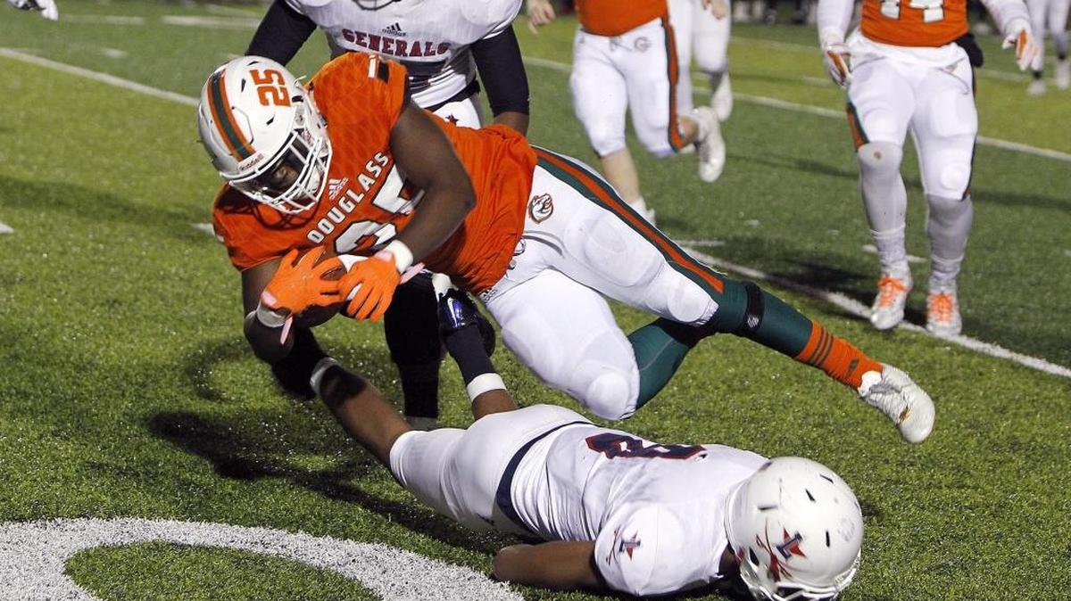 Frederick Douglass' Jefferson Harkless dives for extra yards as he runs against Lafayette at Frederick Douglass football field in Lexington, Ky., Friday, November 3, 2017.