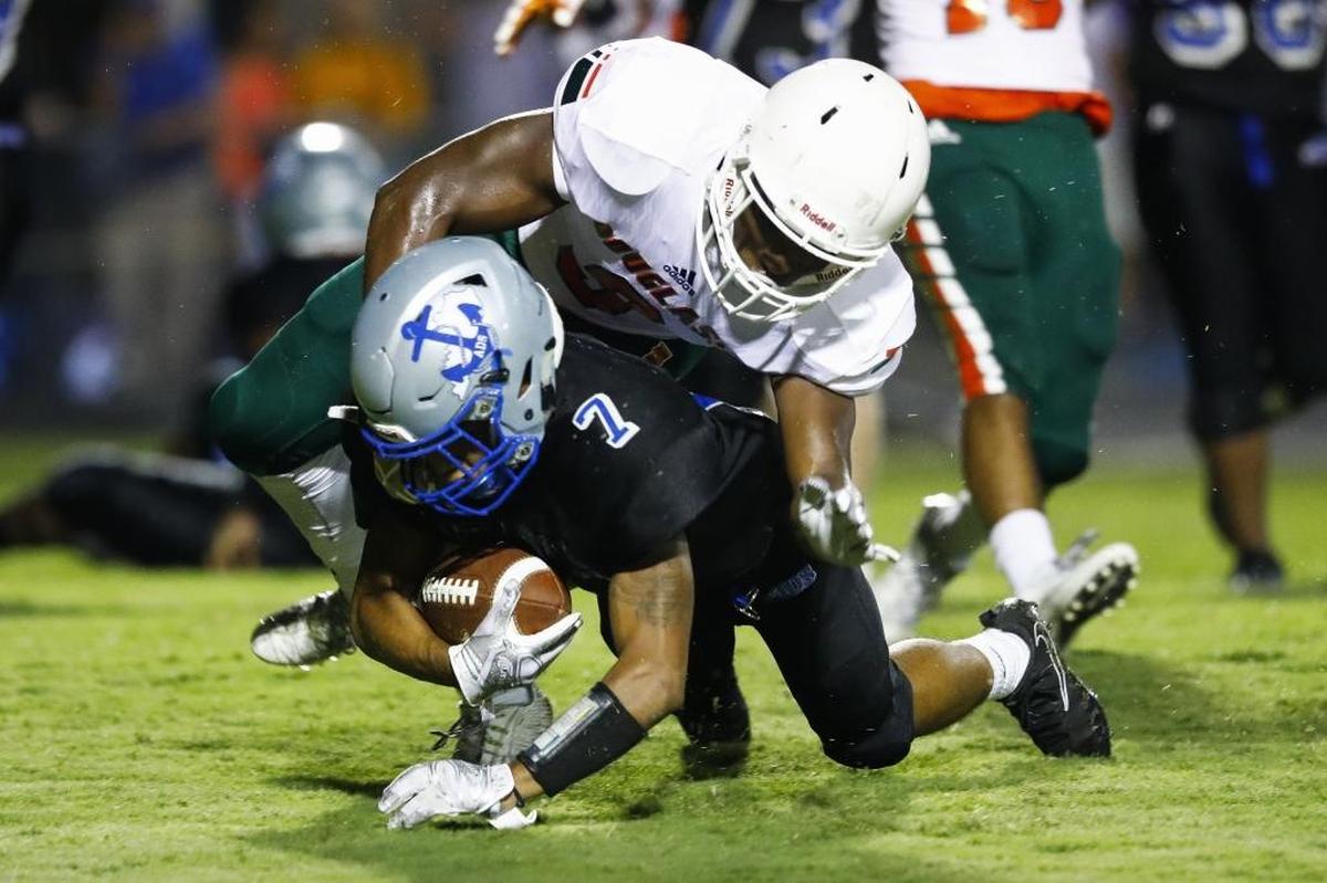 Danville's Dmauriae VanCleave (7) scores a touchdown past Frederick Douglass' Shamarr Taylor (9) in the first quarter of their game at Danville High School in Danville, Ky., Saturday, Aug 19, 2017.