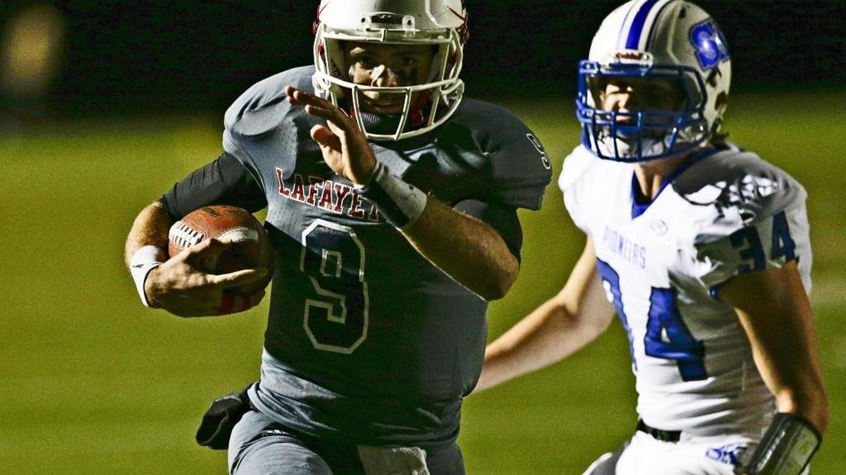 Lafayette quarterback Walker Wood goes in for a first quarter touchdown as Lafayette played Simon Kenton in the regional finals on Friday November 18, 2016 in Lexington, Ky.