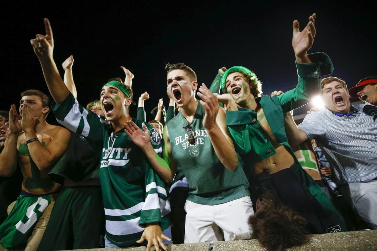 Trinity students celebrates a touchdown from Trinity's Jacob McCarthy (24) during a game against St. Xavier at Papa John's Cardinal Stadium in Louisville, Ky., Friday, Sept. 29, 2017. Trinity beat St. Xavier 28-0.
