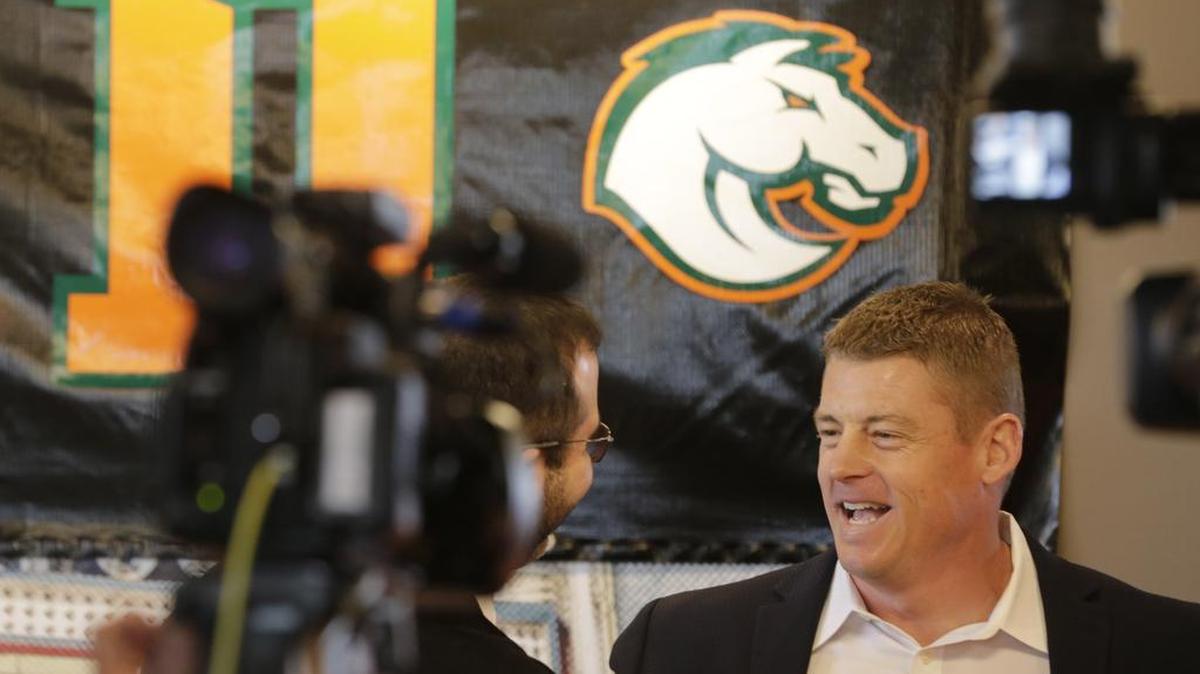 Frederick Douglass Principal Lester Diaz introduced Brian Landis, right, as the first football coach at Mod Pizza in Lexington, Ky., on Jan. 2, 2017. Also announced was the mascot, a stallion and school colors, Keeneland Green and orange.