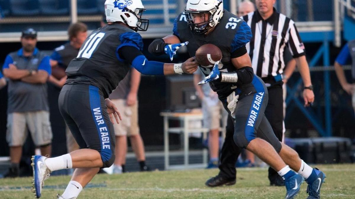 Lexington Christian's Brayden Miller (10) handed the ball to Dillon Wheatley (32) as LCA hosted Estill County on Friday Sept. 9, 2016 in Lexington, Ky.