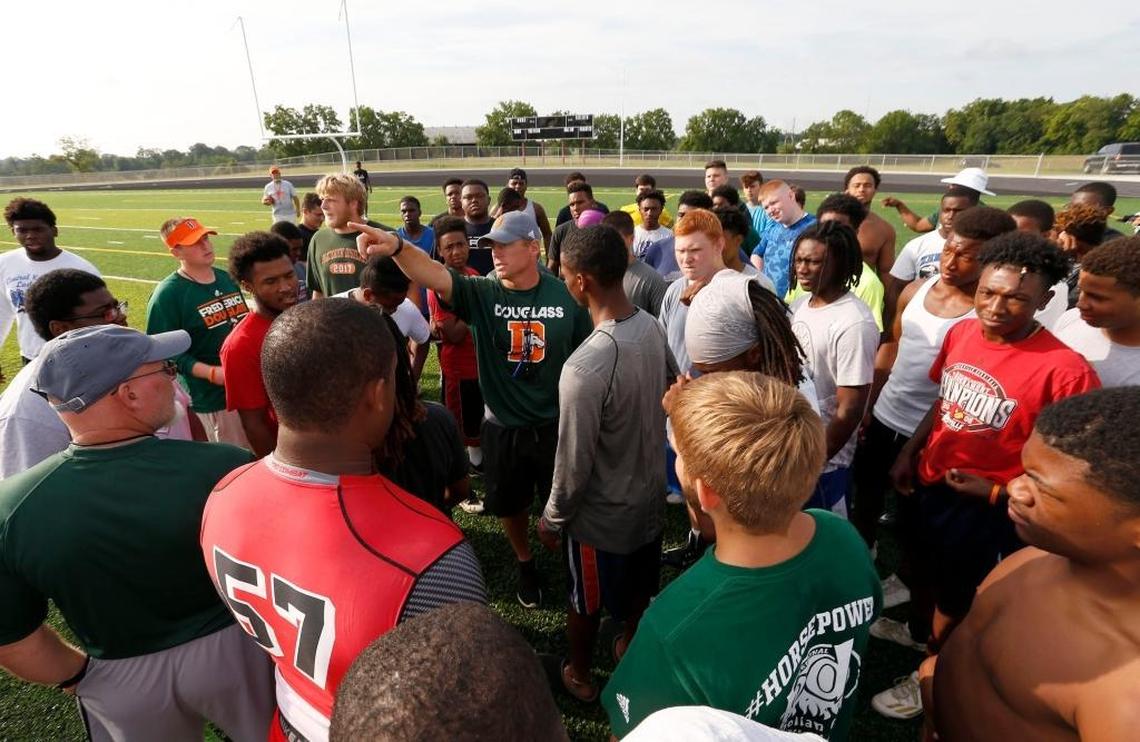 Head coach Brian Landis talked to the team during Frederick Douglass High School’s football practice at the new school, 2000 Winchester Rd. in Lexington, Ky., Friday, July 14, 2017. The school will open this fall.