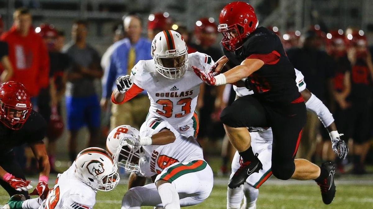 Scott County’s Austin Barnett, shown here running against Frederick Douglass last season, rushed for 216 yards and six TDs on 29 carries in the Cardinals’ 59-28 win over Lafayette last Friday.