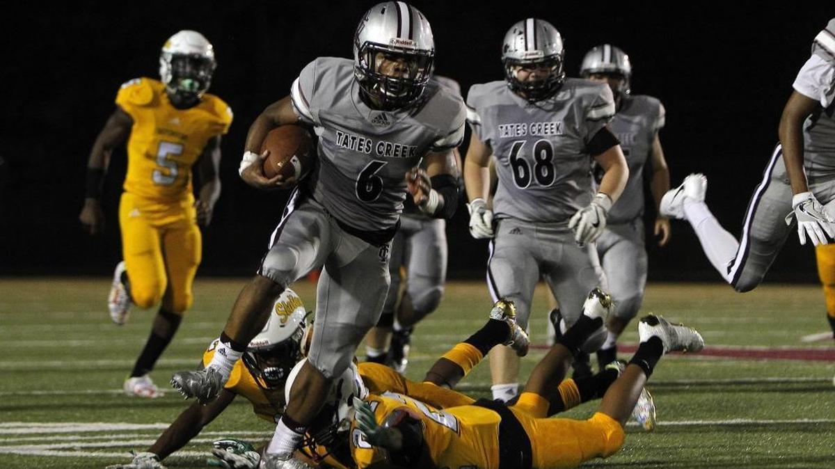 Tates Creek's Laron Warner breaks tackles as he runs for a large gain against Bryan Station at Tates Creek in Lexington, Ky., Friday, September 15, 2017.