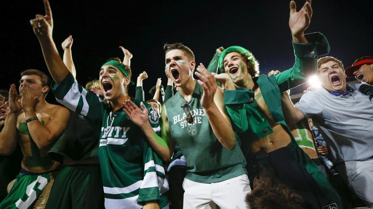 Trinity students celebrates a touchdown from Trinity's Jacob McCarthy (24) during a game against St. Xavier at Papa John's Cardinal Stadium in Louisville, Ky., Friday, Sept. 29, 2017. Trinity beat St. Xavier 28-0.