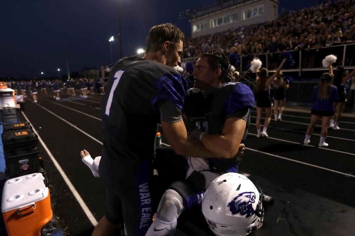 LCA quarterback Logan Nieves comforts Wade Drake following Drake's injury against Lexington Catholic at Lexington Christian Academy in Lexington, Ky., Friday, September 8, 2017.
