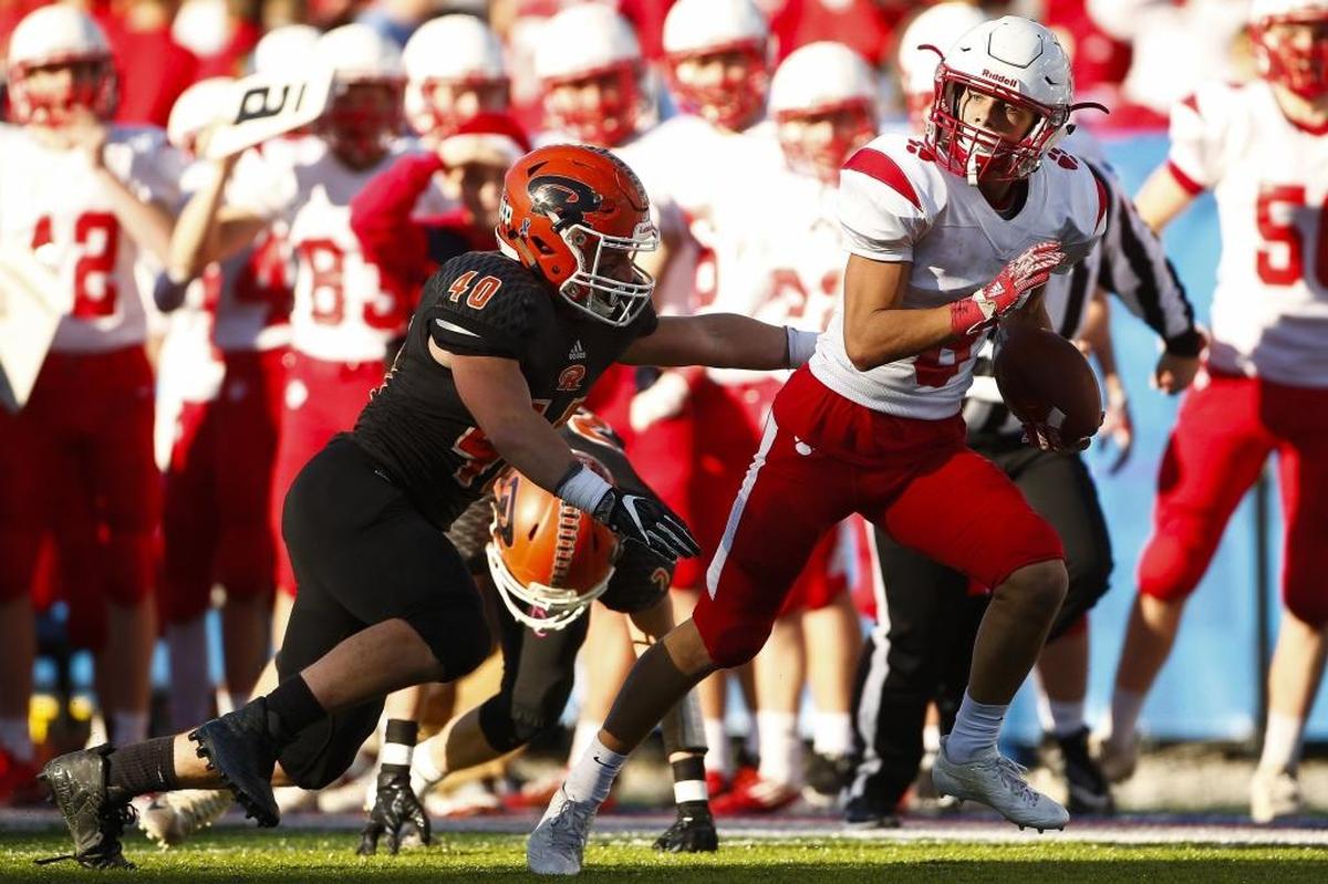Beechwood's Daniel Mescher (8) runs the ball past Raceland's Trevor Thornsberry (40) during the Class A Russell Athletic/KHSAA Commonwealth Gridiron Bowl championship game at Kroger Field in Lexington, Ky., Friday. Dec.1, 2017. Beechwood beat Raceland 41-0.