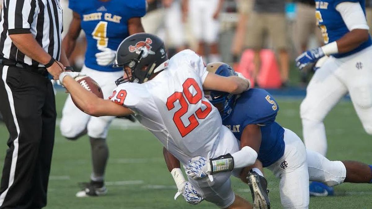 Ryle’s Peyton Howorka (29) was tackled by Henry Clay’s Ramond Jackson (5) during a high school football game at Lexington Catholic on Friday, Aug. 26, 2017. Ryle won, 34-28, in overtime.