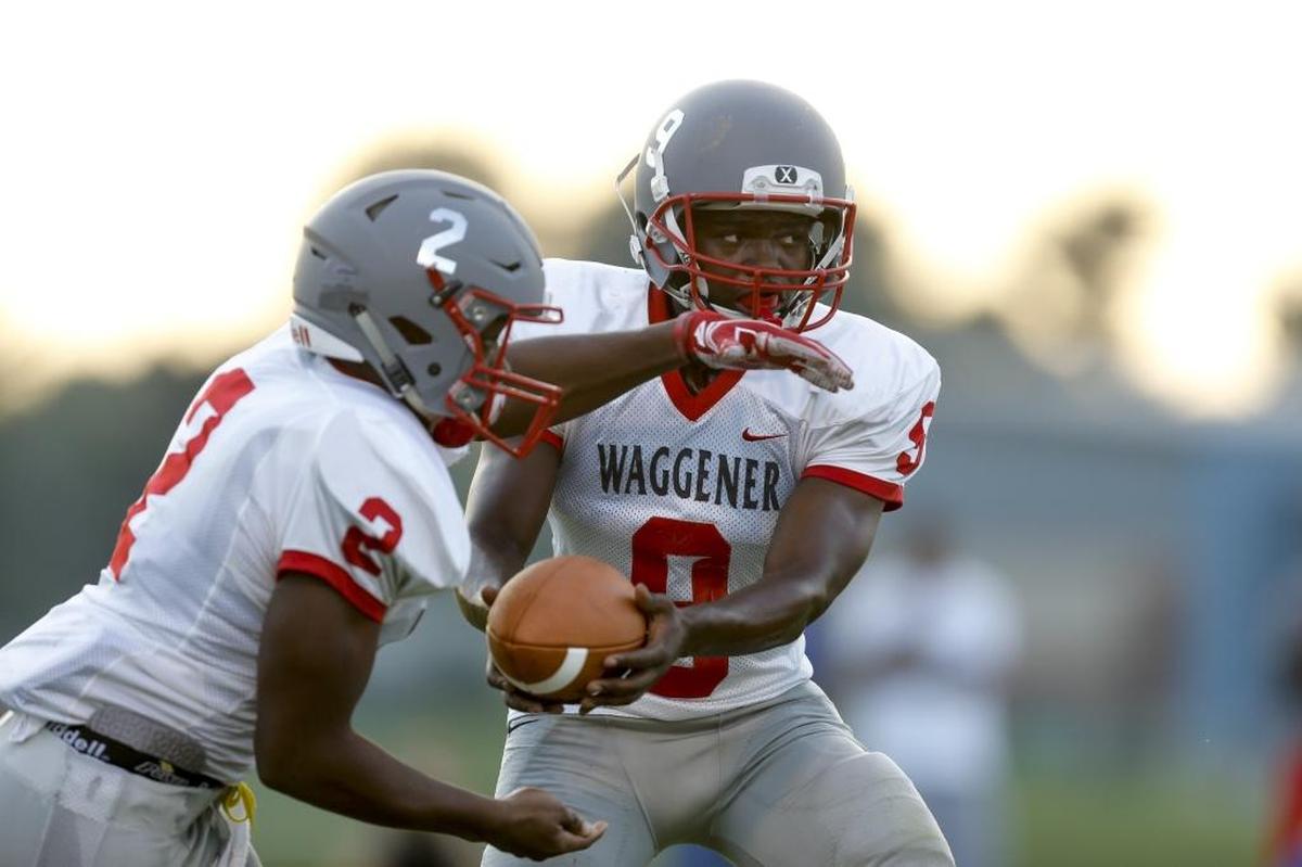 Waggener quarterback Jairus Brents hands the ball off to running back Brandon Jones against Lexington Christian at Lexington Christian Academy in Lexington, KY., on Saturday, August 19, 2017.