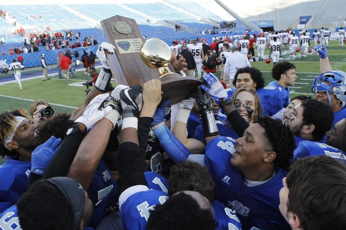 Danville players hoist the championship trophy after defeating Mayfield to win the Class 2A Russell Athletics KHSAA Commonwealth Gridiron Bowl at Kroger Field in Lexington, Ky., Saturday, December 2, 2017.