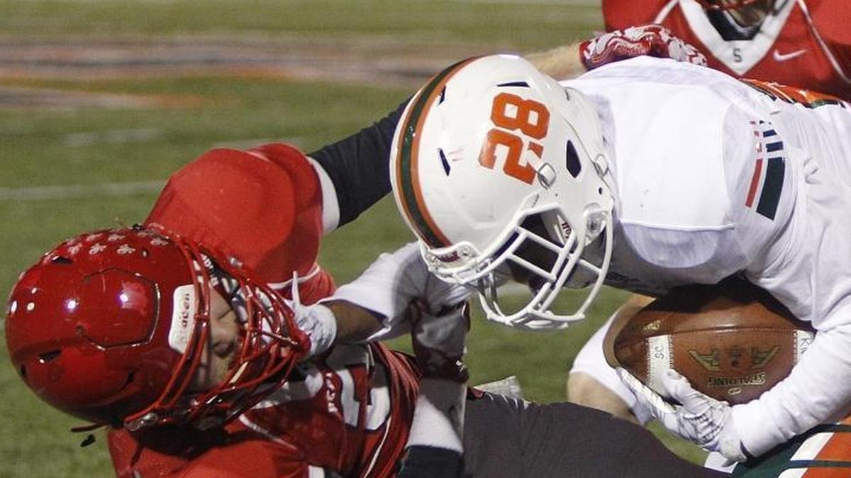 Scott County's Sam Sutton tackled Frederick Douglass' Jaylen Bybee during the Cardinals’ win in the Class 6A playoffs at Toyota Stadium in Georgetown on Friday.