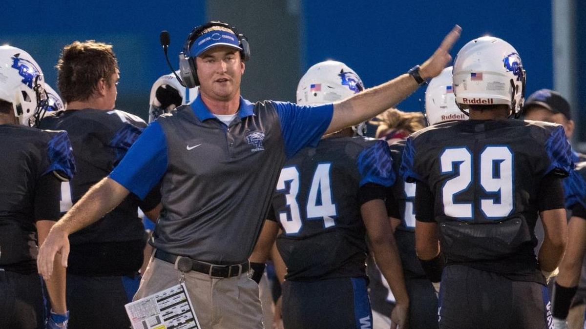 Lexington Christian's head coach Ethan J. Atchley celebrated a 4th down stand as LCA hosted Estill County on Friday Sept. 9, 2016 in Lexington, Ky.