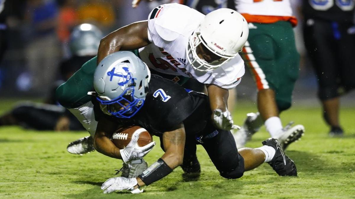 Danville's D’mauriae VanCleave (7) scores a touchdown past Frederick Douglass' Shamarr Taylor (9) in the first quarter of their game at Danville High School in Danville, Ky., Saturday, Aug 19, 2017.