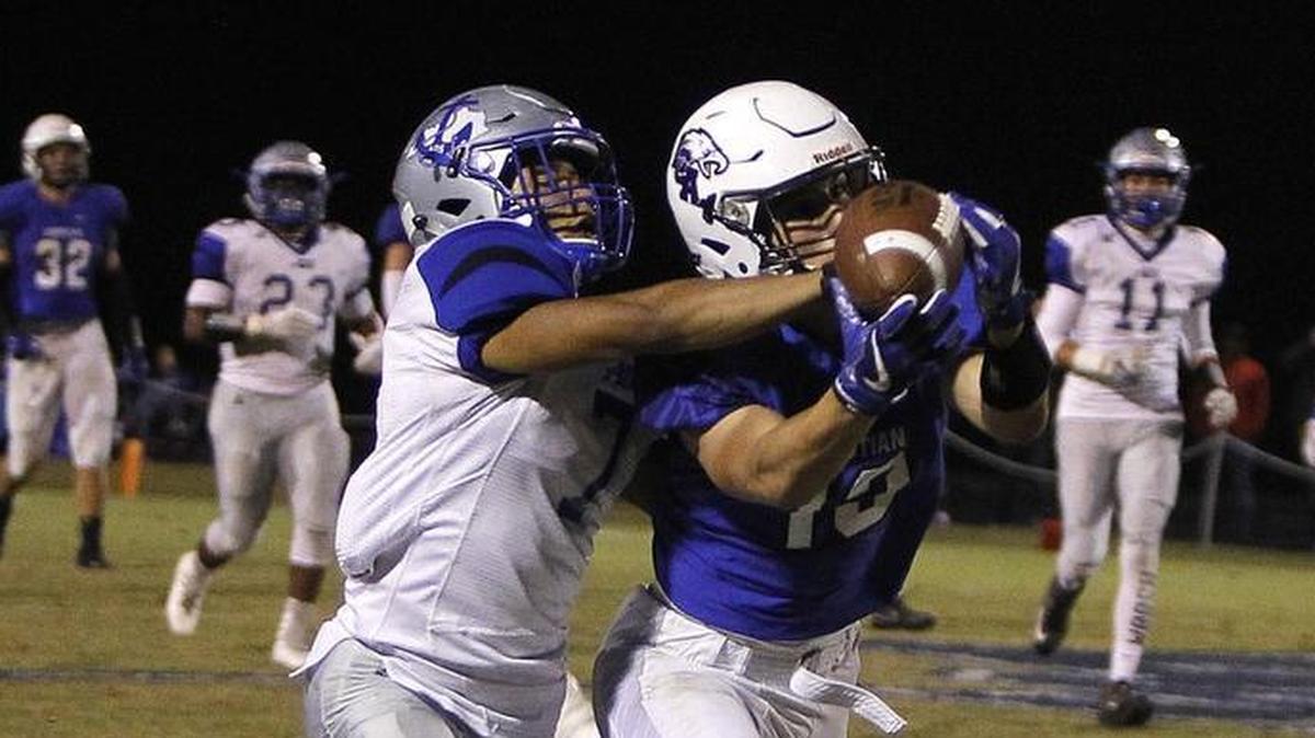LCA's Drayden Burton makes the catch with pressure from Danville's D’mauriae VanCleave, left, at Lexington Christian Academy football stadium in Lexington, Ky., Friday, October 20, 2017.