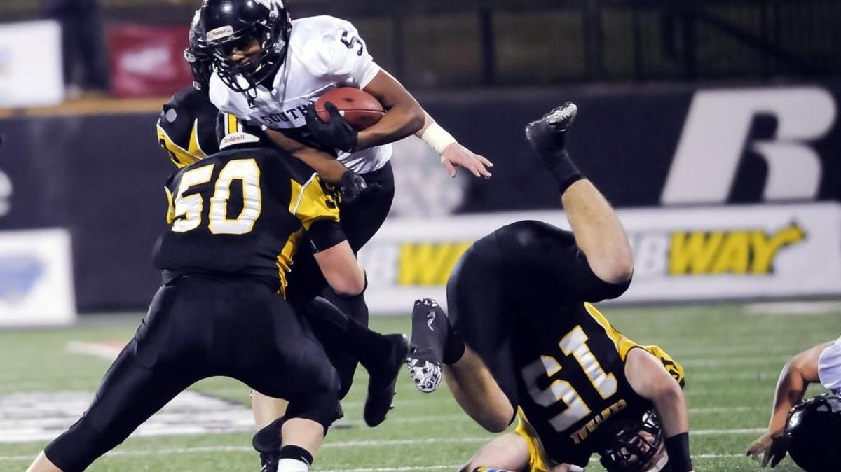 Johnson Central's Garret McCloud (5) gains some yards before getting stopped by Johnson Central's Devon Patrick (50) during the KHSAA Class 4A championship high school football game in Bowling Green, Ky., Sunday, Dec. 6, 2015.