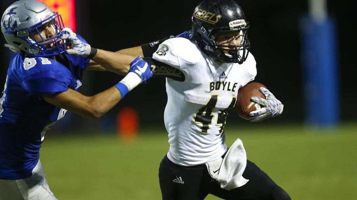 Boyle County Rebels running back Tanner Crawford (44)stiff arms Danville Admirals linebacker Chase Tandy (81) at Danville Admirals Stadium in Danville, Ky., on Thursday, August 31, 2017.