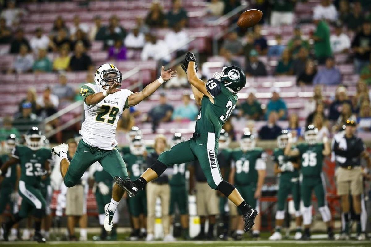 St. Xavier's Harrison Pate (29) breaks up a pass intended for Trinity's Ryan Miller (39) during their game at Papa John's Cardinal Stadium in Louisville, Ky., Friday, Sept. 29, 2017. Trinity beat St. Xavier 28-0.