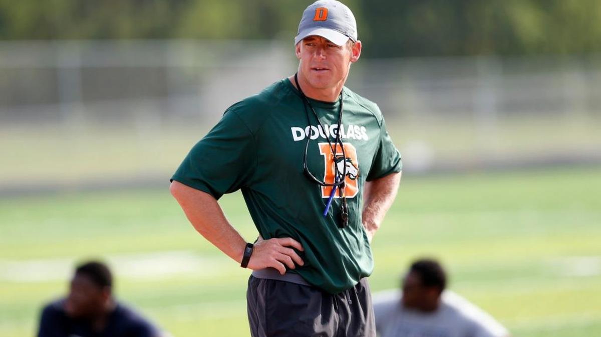 Head Coach Brian Landis watched his team during stretching drills during Frederick Douglass High School's football practice a the new school, 2000 Winchester Rd. in Lexington, Ky., Friday, July 14, 2017. The school will open this fall.