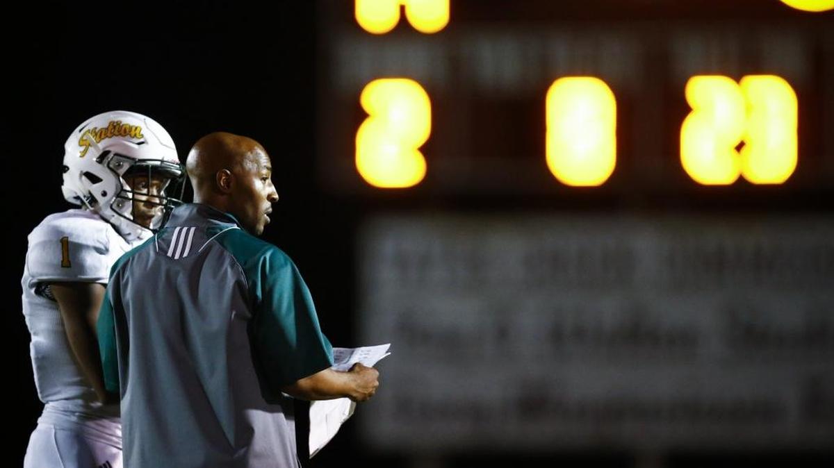 Bryan Station head coach Frank Parks speaks with Bryan Station's Jalen Burbage (1) in the third quarter during the Adidas Kickoff Classic at Tates Creek High School, Friday, Aug. 18. 2017.