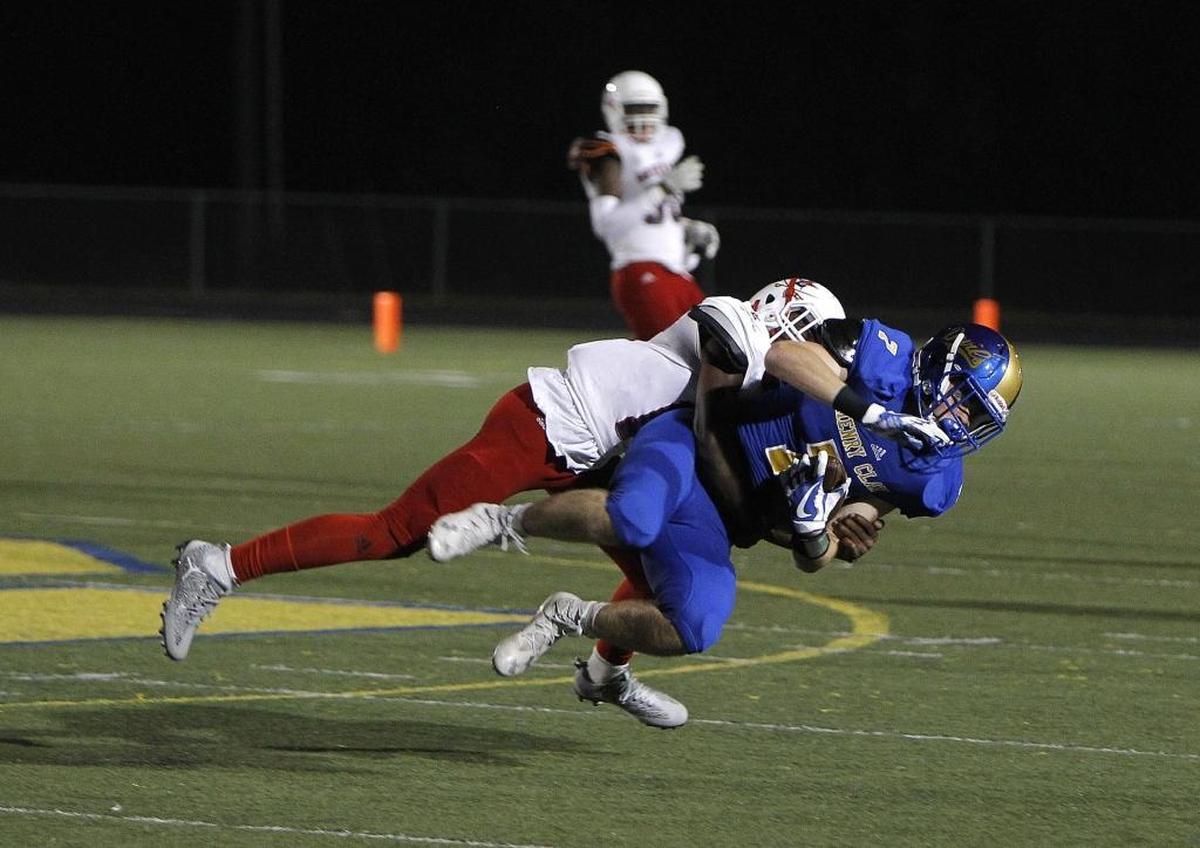 Henry Clay's Noah Gann is tackled by Lafayette's Ernesto Toscan at Henry Clay High School in Lexington, Ky., Friday, September 22, 2017.