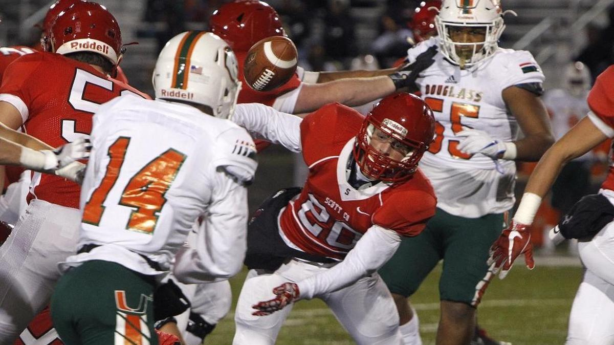 Scott County's Austin Barnett eyes the ball after fumbling on the run against Frederick Douglass at Toyota Stadium in Georgetown, Ky., Friday, November 17, 2017.