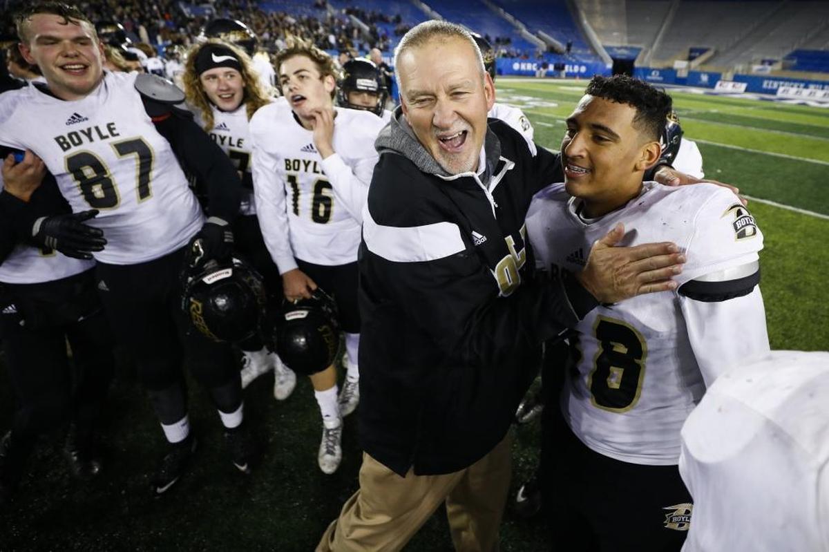 Boyle County's head coach Chuck Smith celebrates with Boyle County's Ezarious Roller (48) after the Class 3A Russell Athletic/KHSAA Commonwealth Gridiron Bowl championship game against Corbin at Kroger Field in Lexington, Ky., Friday. Dec.1, 2017. Boyle County beat Corbin 40-21.