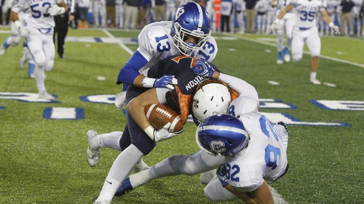 Covington Catholic’s Jack Coldiron and Kameron Butler tackled Madison Southern’s Hunter Richardson during last year’s Class 5A state championship game at Kroger Field in Lexington.