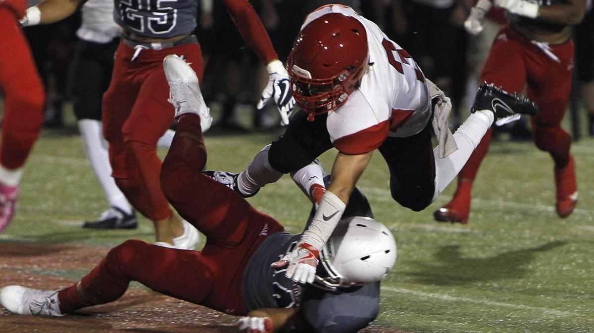 Scott County's Brice Fryman leaps over the defender while running against Lafayette in the Blanton Collier Kickoff Classic at Ishmael Stadium in Lexington, Ky., Friday, August 25, 2017.