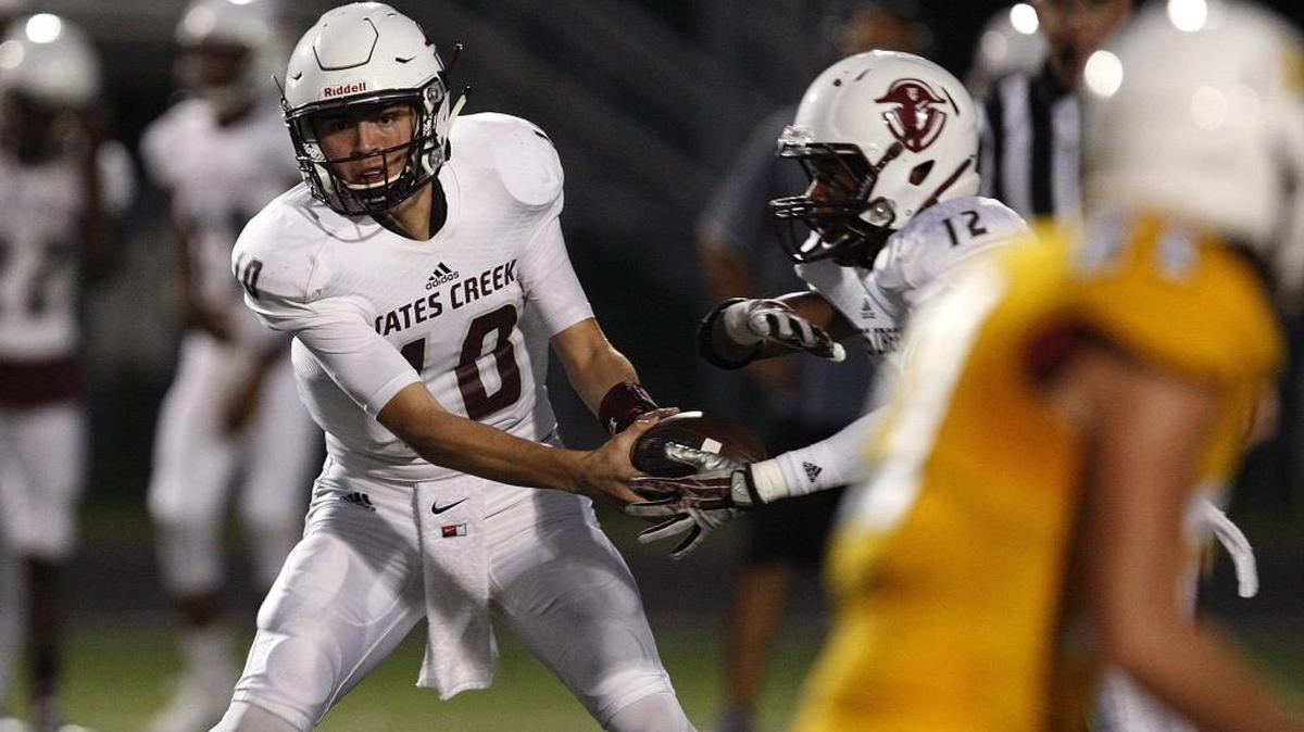 Tates Creek quarterback Cameron Workman hands of to Langston Love against Bryan Station at R. L. Grider Stadium, Ky., Friday, September 23, 2016.