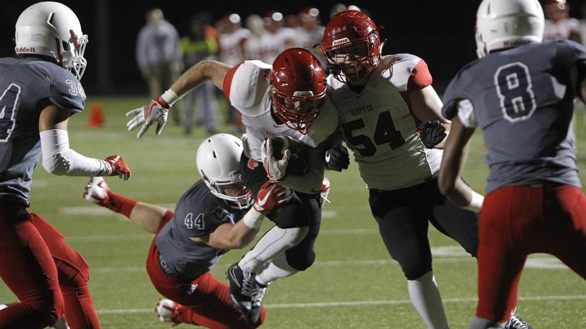 Scott County's Brice Fryman pops through the gap while breaking Austin Blake's tackle while running against Lafayette in the Blanton Collier Kickoff Classic at Ishmael Stadium in Lexington, Ky., Friday, August 25, 2017.