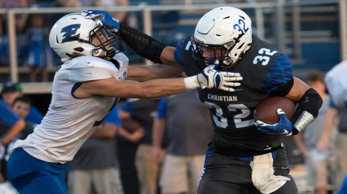 Lexington Christian's Dillon Wheatley (32) stiff-armed Estill County's Dawson Bingham (5) on Friday, Sept. 9, 2016, in Lexington.