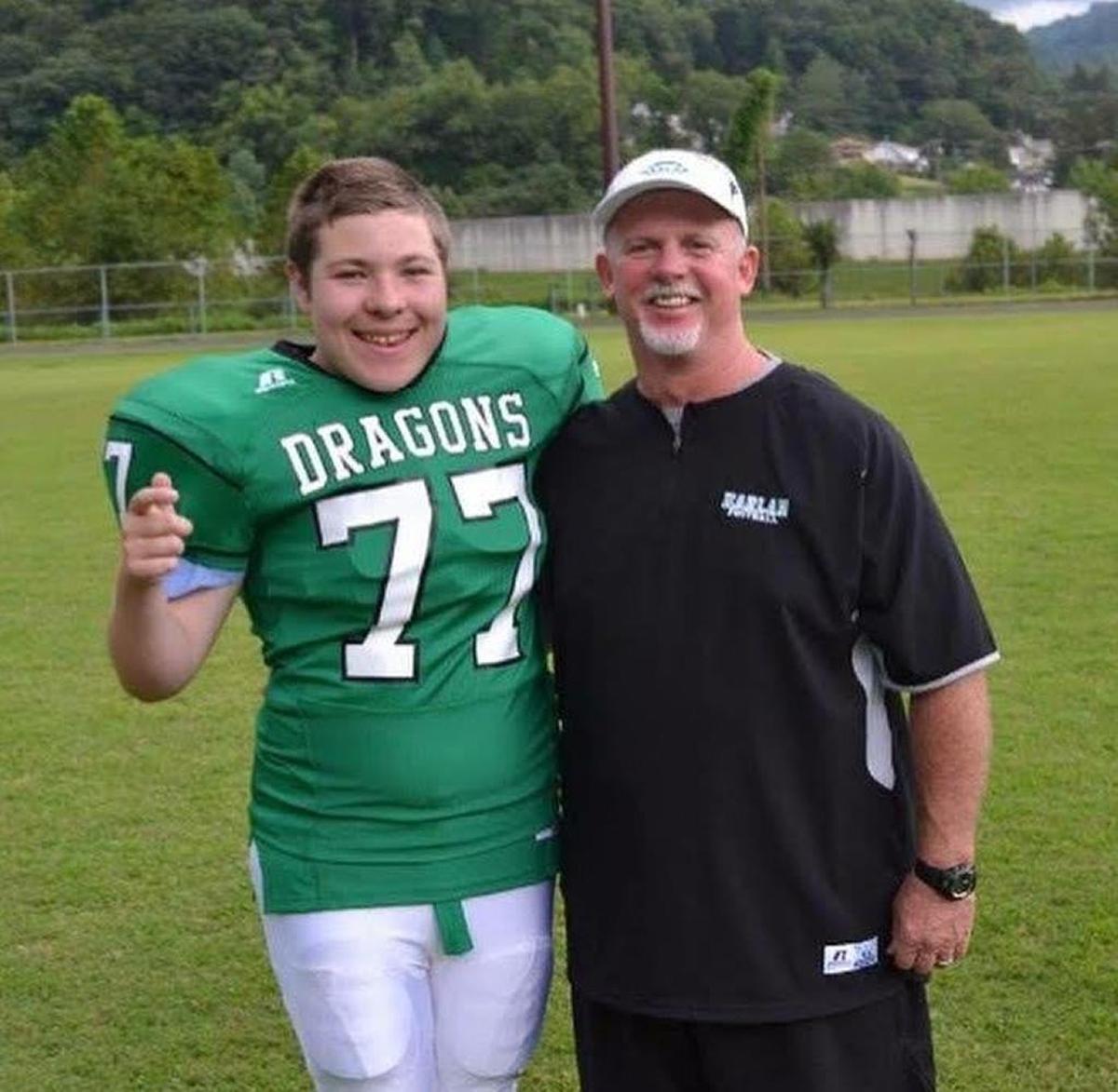 Kyle Allison (left) and Harlan Green Dragons head coach John Luttrell. Allison, a 17-year-old junior on Harlan’s football team, scored a touchdown in the Green Dragons’ playoff game on Friday, November 3, 2017.